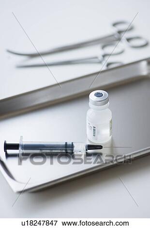 Stock Photo - Close up of syringe and medication, studio shot. Fotosearch
