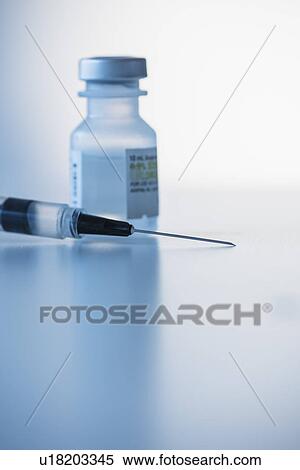 Stock Photography - Close up of syringe and medication, studio shot. Fotosearch