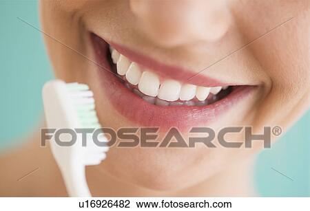 Close-up of woman brushing teeth View Large Photo Image Stock Image - Close-up of woman brushing teeth. Fotosearch