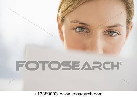 Close-up of young woman reading documents View Large Photo Image Stock Image - Close-up of young woman reading documents. Fotosearch