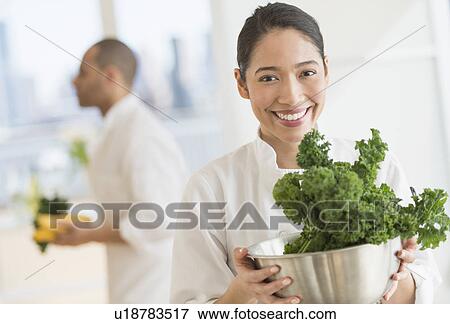 Couple during preparations in kitchen of their own restaurant View Large Photo Image Stock Photo - Couple during preparations in kitchen of their own restaurant. Fotosearch