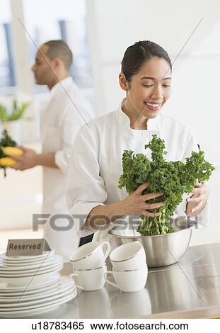 Couple during preparations in kitchen of their own restaurant View Large Photo Image Stock Photography - Couple during preparations in kitchen of their own restaurant. Fotosearch