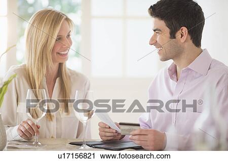 Couple in restaurant, man paying View Large Photo Image Stock Image - Couple in restaurant, man paying. Fotosearch