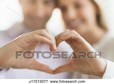 Couple making heart shape with hands View Large Photo Image Stock Photo - Couple making heart shape with hands. Fotosearch
