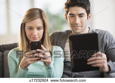 Couple using tablet pc and smartphone View Large Photo Image Picture - Couple using tablet pc and smartphone. Fotosearch