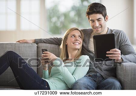 Couple using tablet pc and smartphone View Large Photo Image Stock Photo - Couple using tablet pc and smartphone. Fotosearch