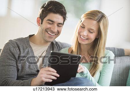Couple using tablet pc View Large Photo Image Stock Image - Couple using tablet pc. Fotosearch