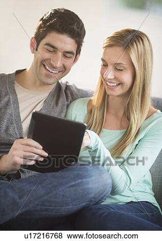 Couple using tablet pc View Large Photo Image Stock Photo - Couple using tablet pc. Fotosearch