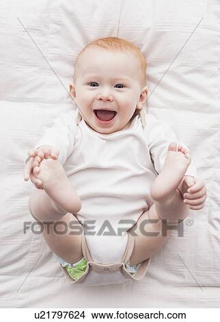 Picture - Directly above portrait of baby boy (18-23 months) lying down. Fotosearch