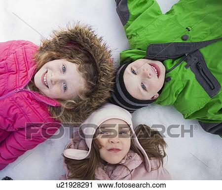 Directly above portrait of three children (2-3, 4-5) lying on snow View Large Photo Image Stock Image - Directly above portrait of three children (2-3, 4-5) lying on snow. Fotosearch