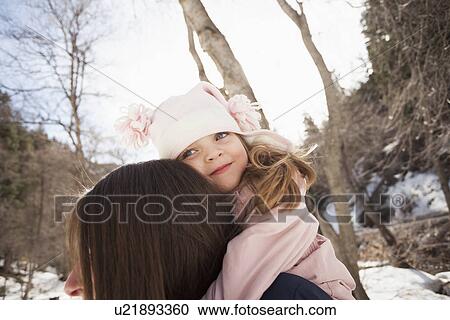 Stock Image - Girl (2-3) hugging her mother . Fotosearch