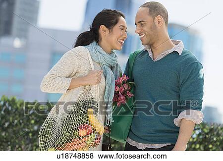 Happy couple with grocery shopping bags View Large Photo Image Stock Photo - Happy couple with grocery shopping bags. Fotosearch