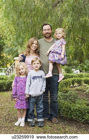 Stock Photo - Happy family with three children (2-3, 4-5, 6-7). Fotosearch