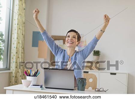 Happy woman in office raising arms up View Large Photo Image Stock Image - Happy woman in office raising arms up. Fotosearch