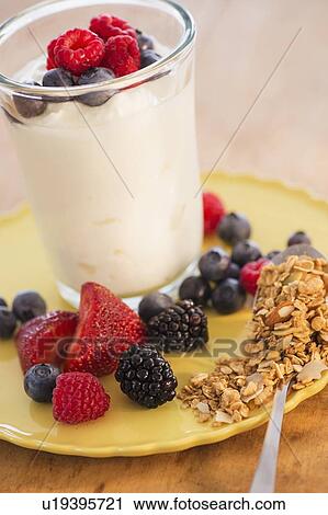 Stock Image - Healthy breakfast with fruits, cereal and yoghurt. Fotosearch