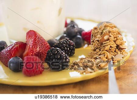 Stock Photo - Healthy breakfast with fruits, cereal and yoghurt. Fotosearch