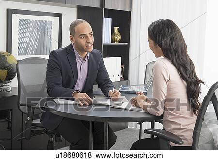 Man and woman at meeting in office View Large Photo Image Stock Photo - Man and woman at meeting in office. Fotosearch