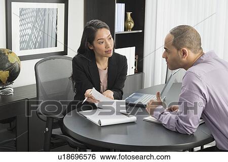 Man and woman at meeting in office View Large Photo Image Stock Photograph - Man and woman at meeting in office. Fotosearch