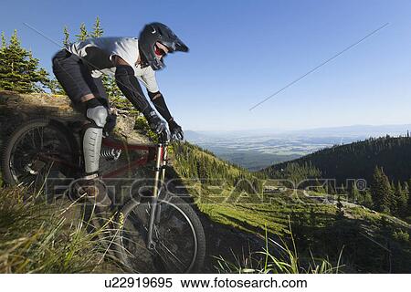 Man mountain biking View Large Photo Image Stock Photography - Man mountain biking. Fotosearch