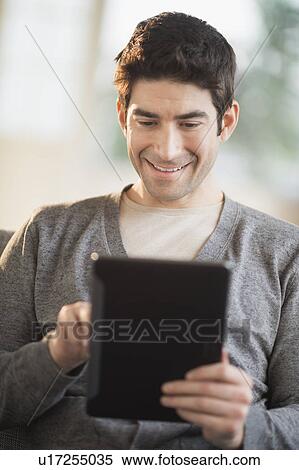 Man using tablet pc View Large Photo Image Stock Photography - Man using tablet pc. Fotosearch