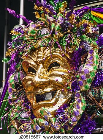 Stock Photo - Mardi Gras mask hanging on balcony's railing. Fotosearch