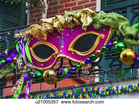 Mardi Gras mask hanging on balcony's railing View Large Photo Image Stock Photo - Mardi Gras mask hanging on balcony's railing. Fotosearch