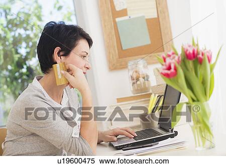Mature woman doing online shopping View Large Photo Image Stock Photography - Mature woman doing online shopping. Fotosearch