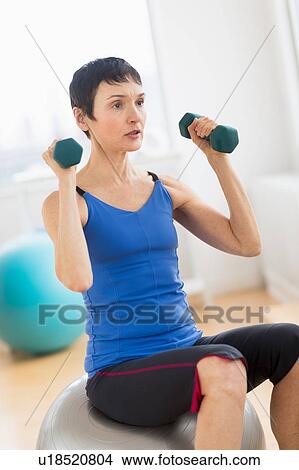Mature woman exercising in gym View Large Photo Image Picture - Mature woman exercising in gym. Fotosearch