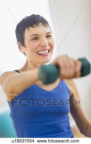 Mature woman exercising in gym View Large Photo Image Picture - Mature woman exercising in gym. Fotosearch