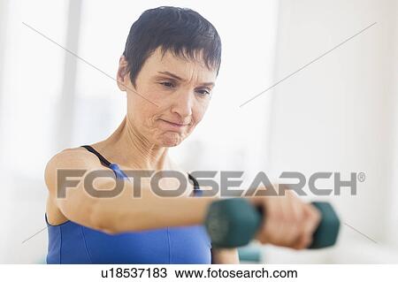 Mature woman exercising in gym View Large Photo Image Stock Image - Mature woman exercising in gym. Fotosearch