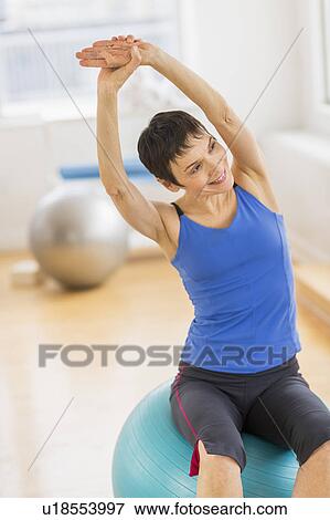 Mature woman exercising in gym View Large Photo Image Stock Photo - Mature woman exercising in gym. Fotosearch