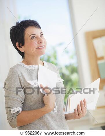 Mature woman holding letters View Large Photo Image Stock Photo - Mature woman holding letters. Fotosearch