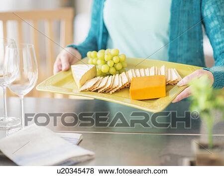 Mid section of woman holding appetizer plate View Large Photo Image Stock Photo - Mid section of woman holding appetizer plate. Fotosearch