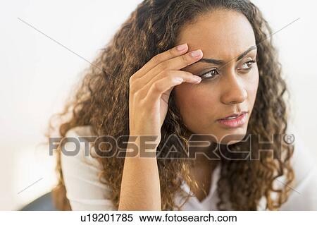 Stock Photography - Office worker sitting by desk with laptop. Fotosearch