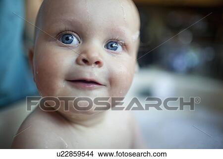 Picture - Portrait of baby girl (2-5 months) in bathtub. Fotosearch