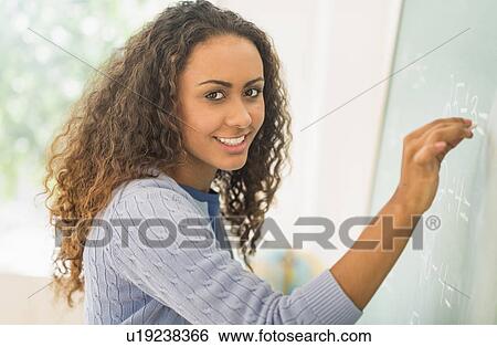 Portrait of elementary school teacher in class View Large Photo Image Stock Photograph - Portrait of elementary school teacher in class. Fotosearch