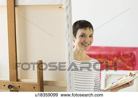 Portrait of female artist in her studio View Large Photo Image Stock Photo - Portrait of female artist in her studio. Fotosearch