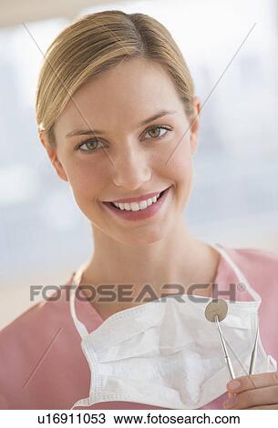 Stock Image - Portrait of female dentist. Fotosearch