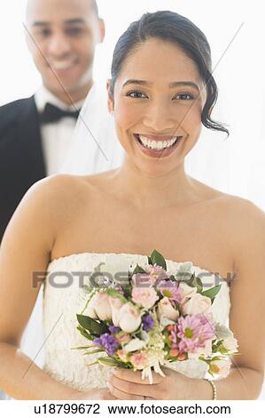 Stock Image - Portrait of happy newlywed couple. Fotosearch