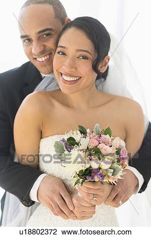 Stock Image - Portrait of happy newlywed couple. Fotosearch