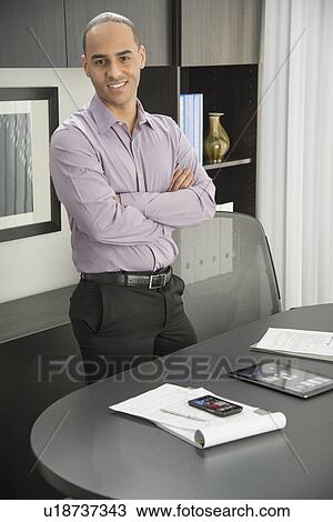 Stock Image - Portrait of male executive in office. Fotosearch