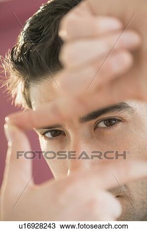 Portrait of man making finger frame View Large Photo Image Stock Image - Portrait of man making finger frame. Fotosearch