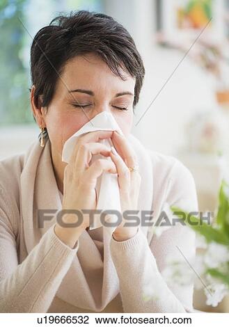 Portrait of mature woman blowing nose View Large Photo Image Stock Image - Portrait of mature woman blowing nose. Fotosearch