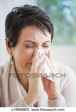 Portrait of mature woman blowing nose View Large Photo Image Stock Image - Portrait of mature woman blowing nose. Fotosearch