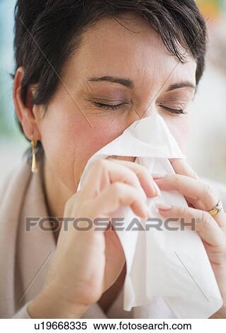 Portrait of mature woman blowing nose View Large Photo Image Stock Photography - Portrait of mature woman blowing nose. Fotosearch