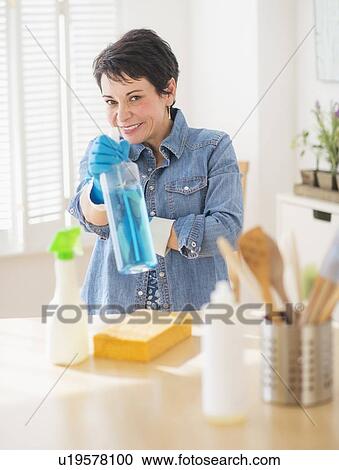 Portrait of mature woman cleaning kitchen View Large Photo Image Stock Image - Portrait of mature woman cleaning kitchen. Fotosearch