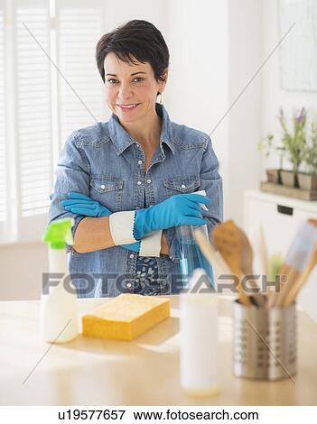 Portrait of mature woman cleaning kitchen View Large Photo Image Stock Photo - Portrait of mature woman cleaning kitchen. Fotosearch