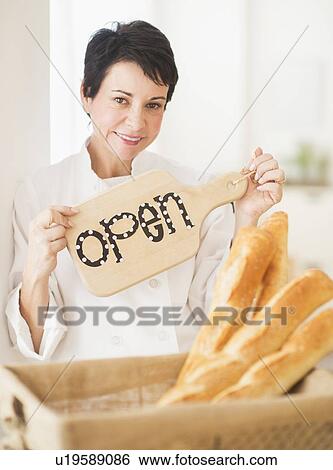 Portrait of mature woman holding basket with baguettes View Large Photo Image Stock Photograph - Portrait of mature woman holding basket with baguettes. Fotosearch