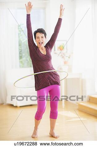 Portrait of mature woman hula-hooping View Large Photo Image Stock Photo - Portrait of mature woman hula-hooping. Fotosearch