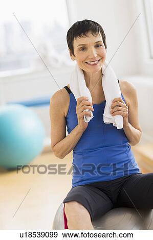 Stock Photo - Portrait of mature woman in gym. Fotosearch